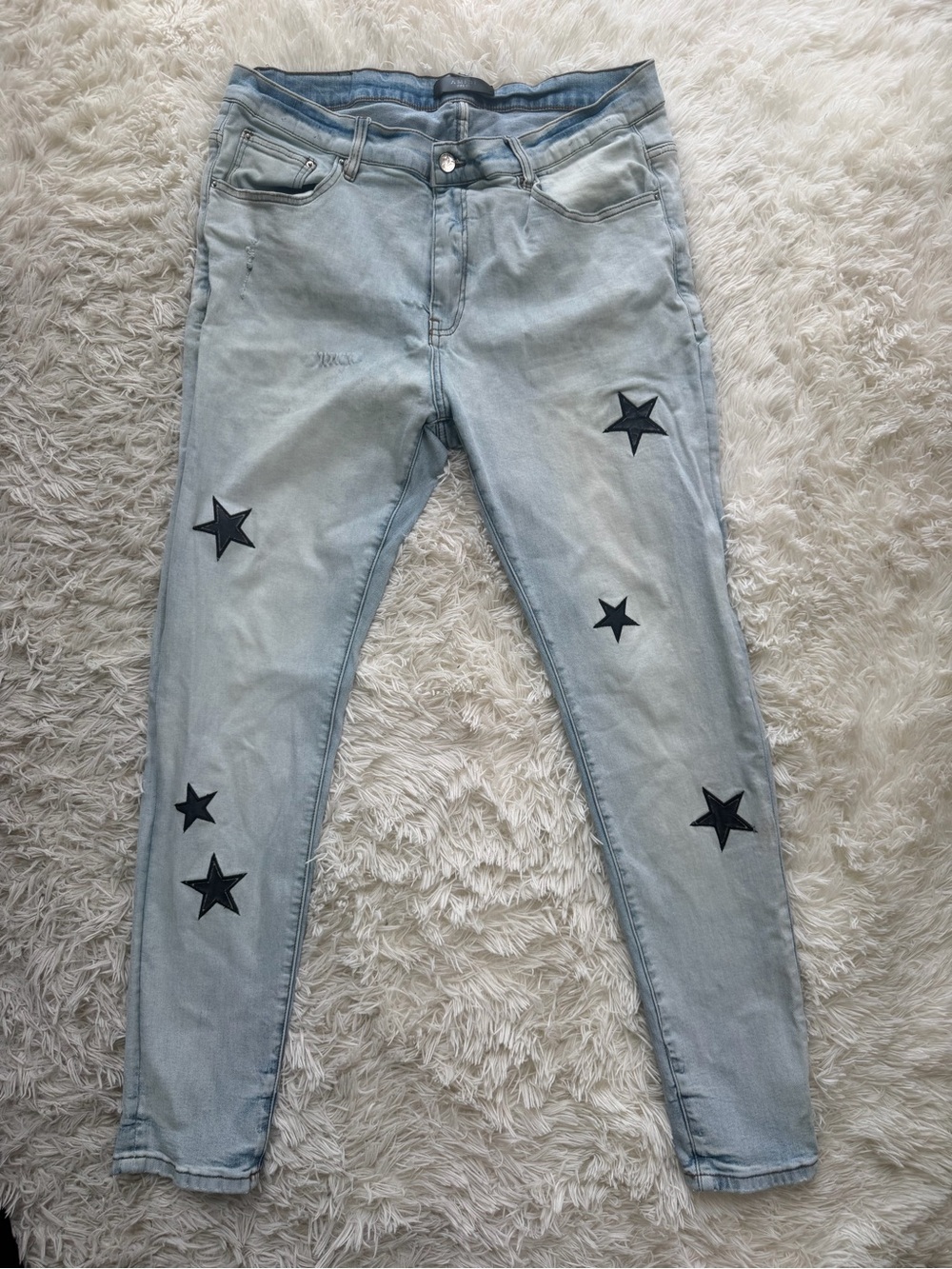 AMIRI Light Blue Skinny Jeans with Black Star Appliqués
